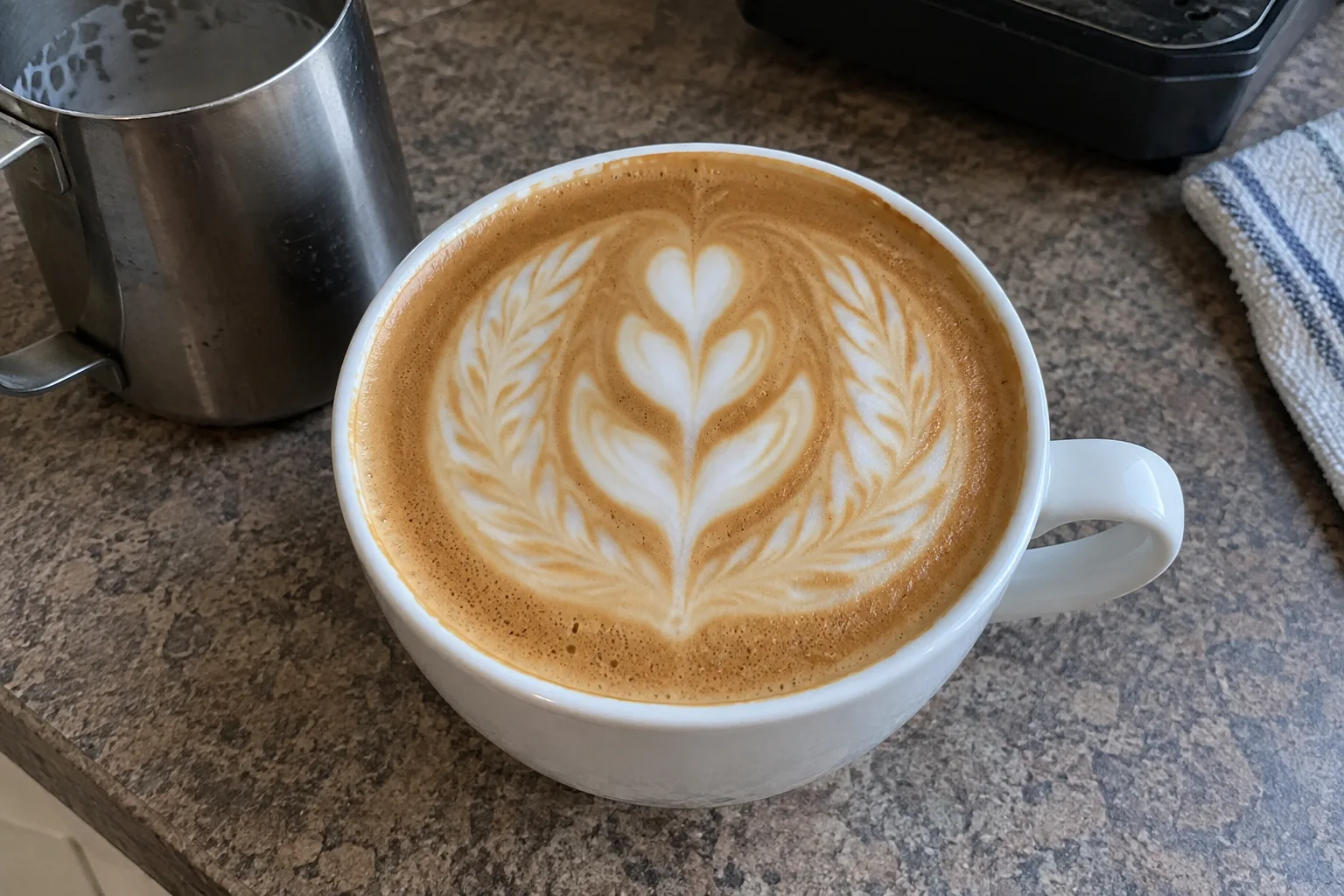 A winged tulip pattern with feathered sides and stacked central layers in a coffee cup